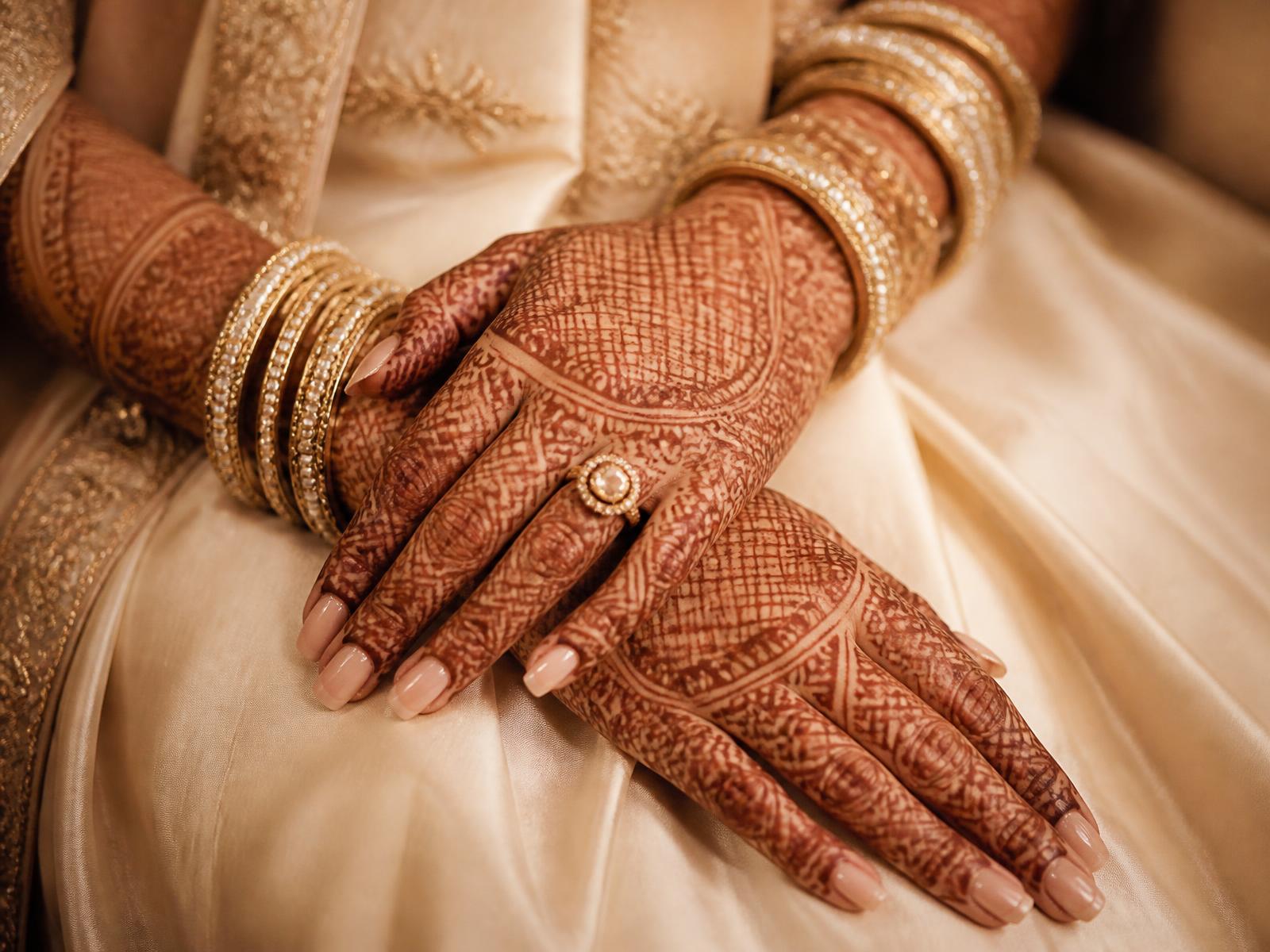 Full bridal mehendi design covering an Indian bride's hands and arms