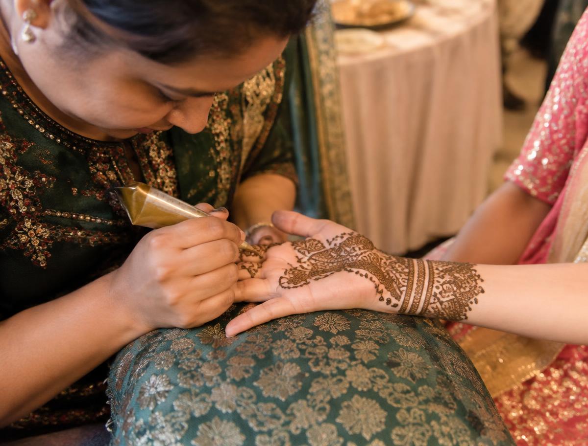 Mehndi artist applying henna at a wedding function in Hyderabad